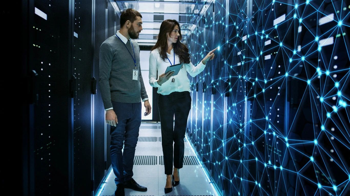 A man and woman are looking at the data center.
